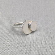 Personalised recycled silver ring with mother and daughter circles on fabric