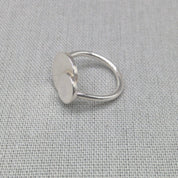 Angled view of personalised silver ring with large and small circle