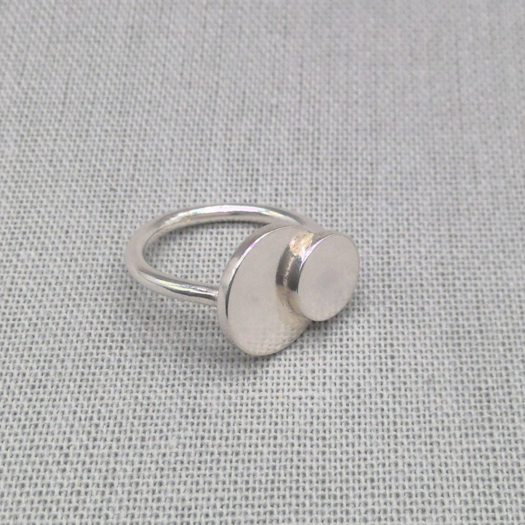 Side view of personalised silver ring showing two connected discs