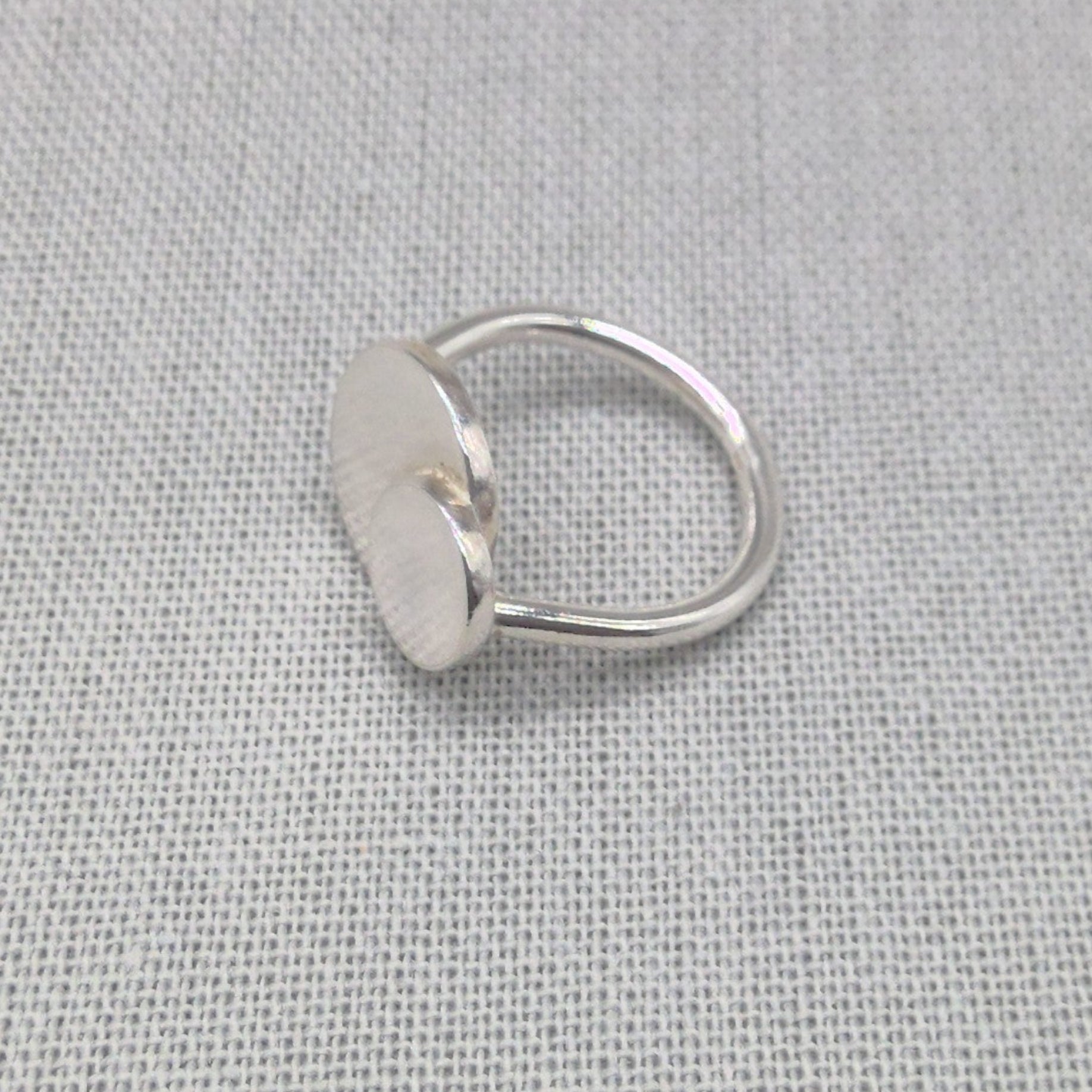 Top-down view of mother daughter personalised silver ring