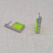 Close-up of neon green Perspex panel on hammered silver earring