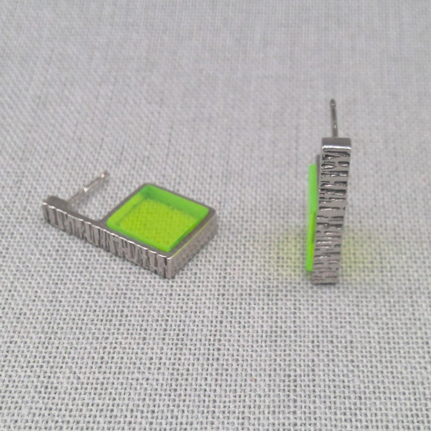 Side view of single neon green Perspex silver earring