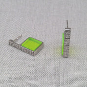 Side view of single neon green Perspex silver earring
