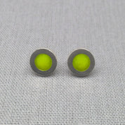Close-up of green neon resin recycled silver stud earrings