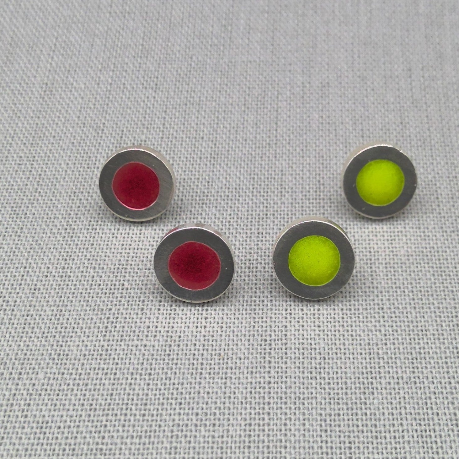 Two pairs of neon resin silver studs in red and green