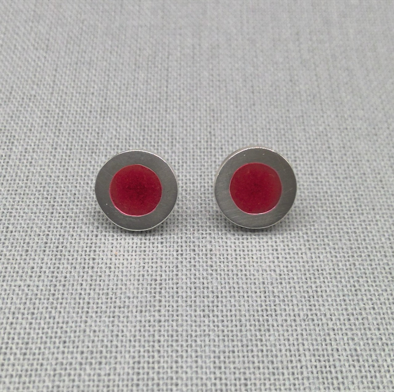 Alternate close-up of red neon resin silver stud earrings