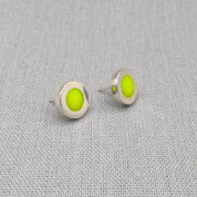 Close-up of yellow neon resin recycled silver stud earrings