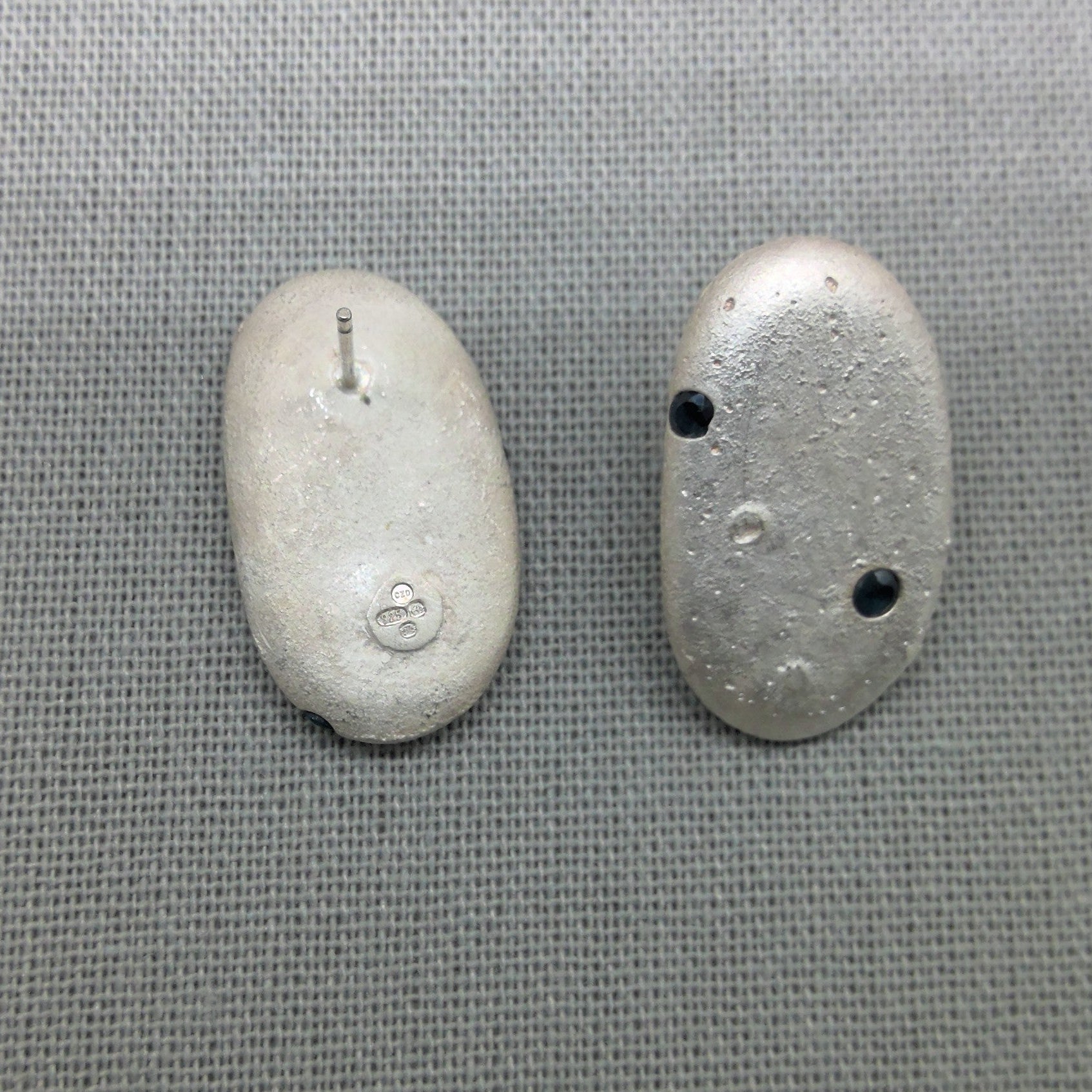 Sterling silver pebble earrings with natural blue sapphire accents
