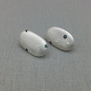 Close-up silver pebble earrings, natural organic texture