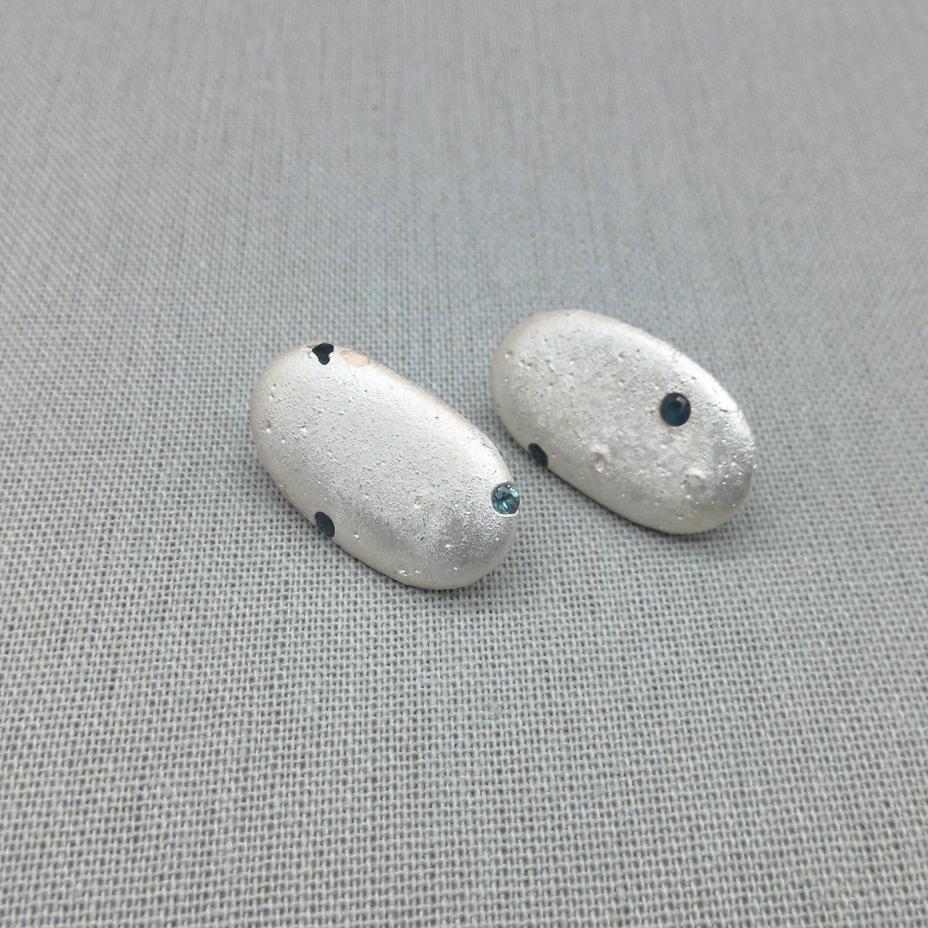 Sterling silver pebble earrings with blue sapphire detail
