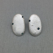 Silver pebble earrings cast from Cornish beach stones, set with blue sapphires