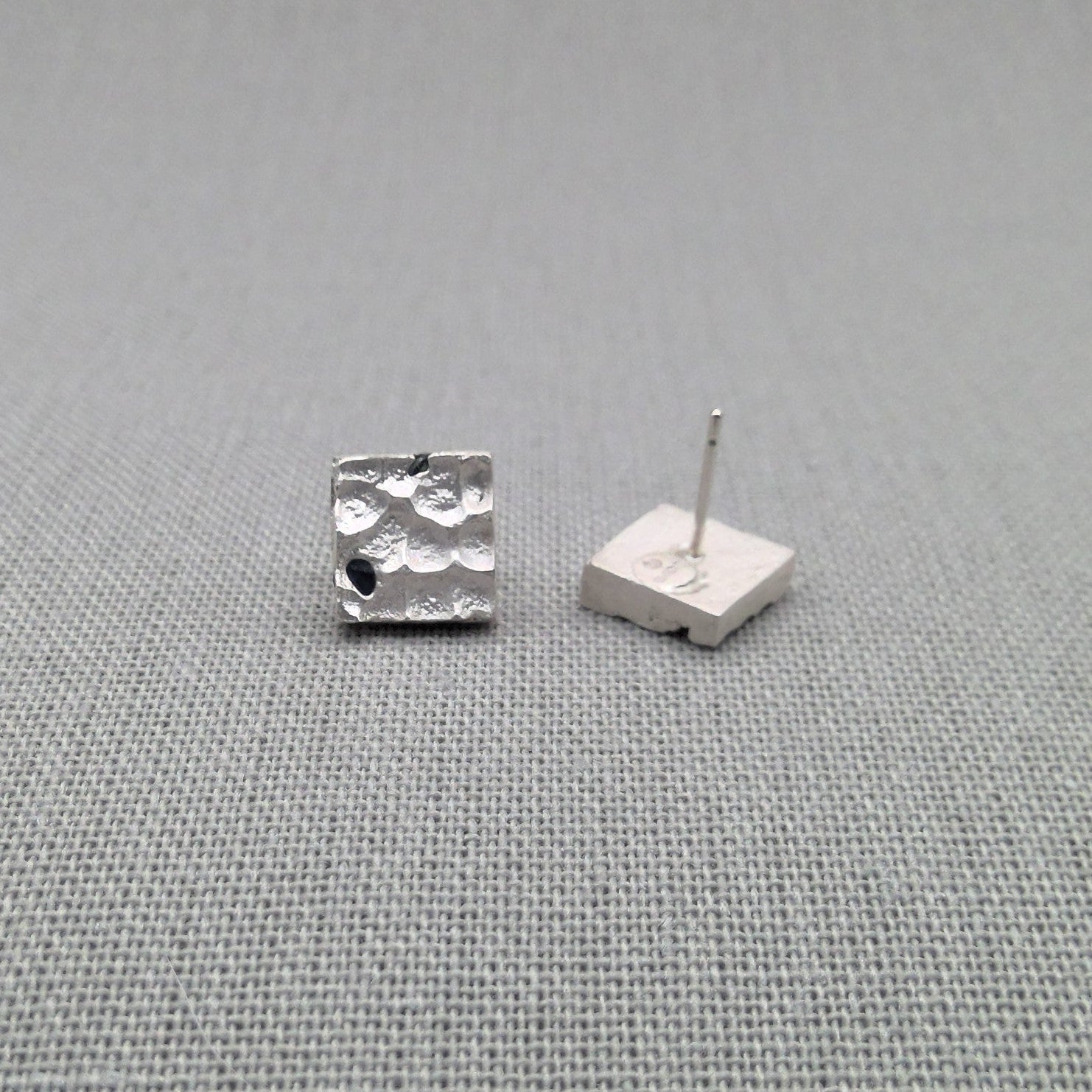 Sterling silver stud earring with blue sapphire, side view