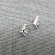Textured silver stud earrings with natural blue sapphire gemstones