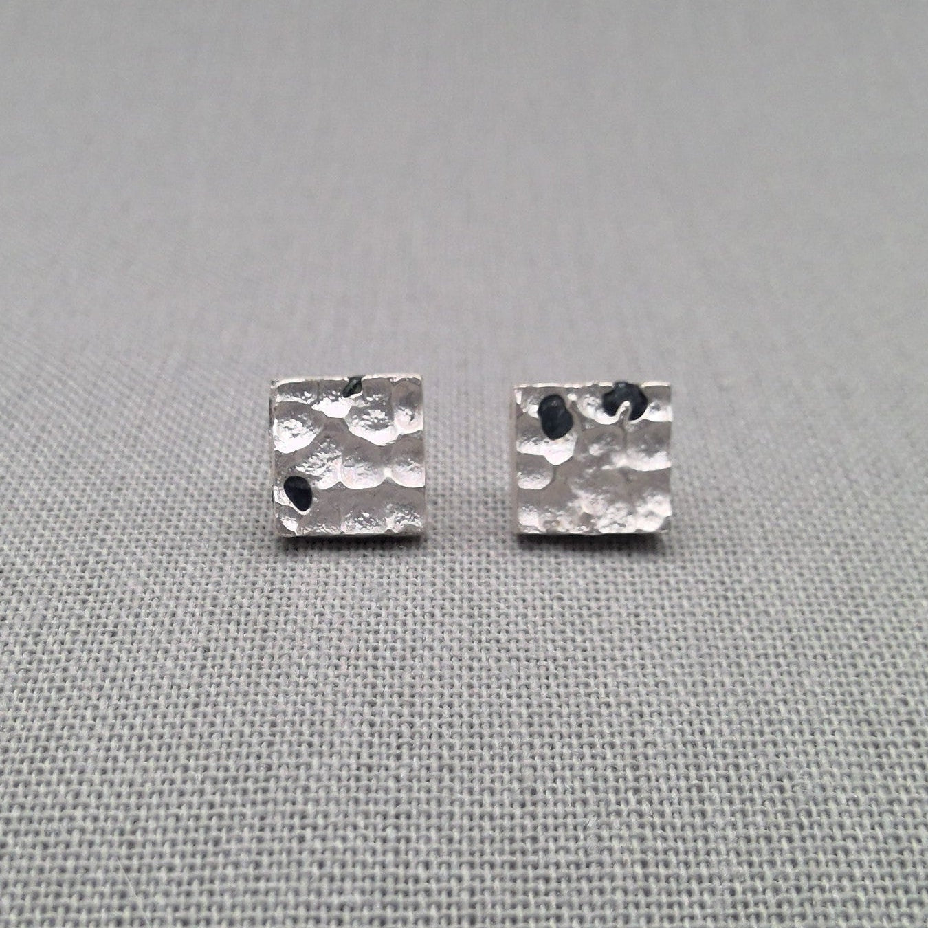 Textured sterling silver stud earrings with natural blue sapphires