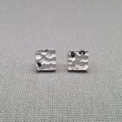 Textured sterling silver stud earrings with natural blue sapphires