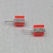 Angled view of orange textured recycled silver studs