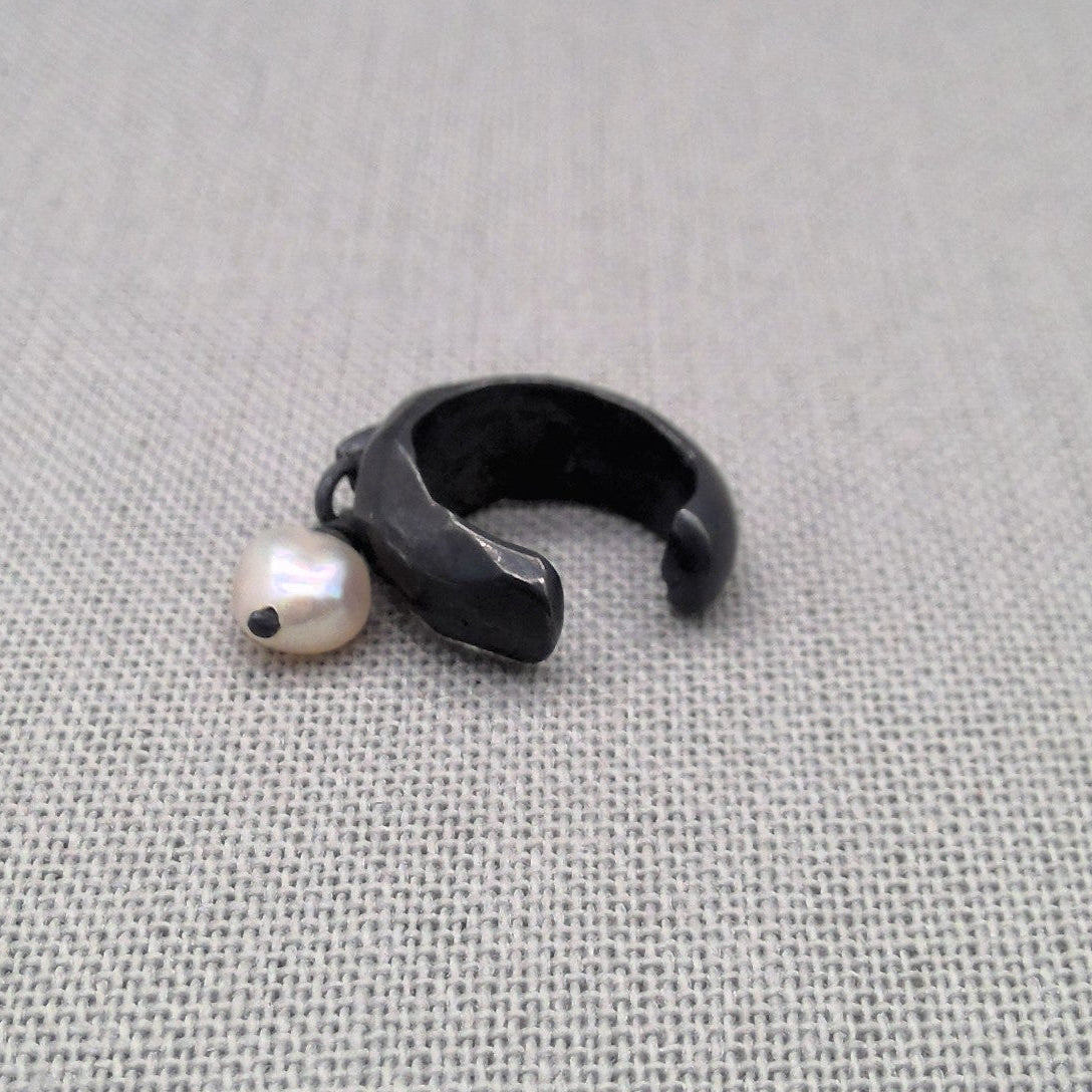 Oxidized recycled silver ear cuff with dangling freshwater pearl on fabric