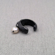 Oxidized recycled silver ear cuff with dangling freshwater pearl on fabric
