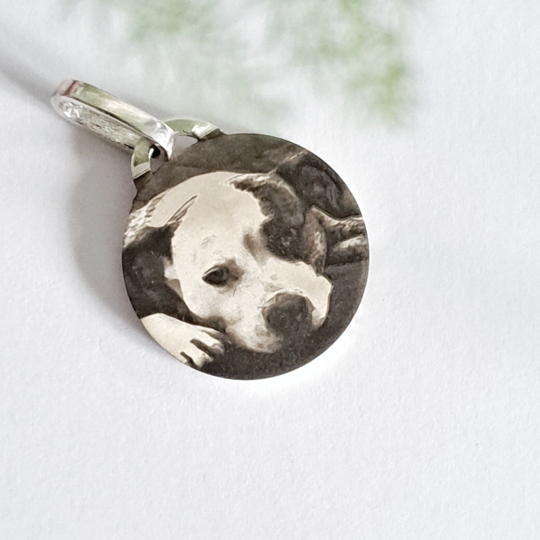 Close-up of pet photo engraved on recycled silver pendant