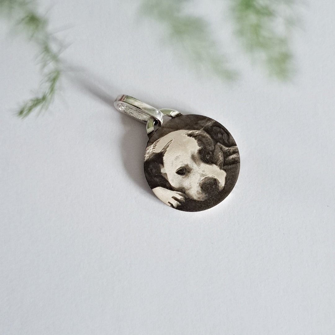 Personalised pet photo pendant hanging outdoors against greenery