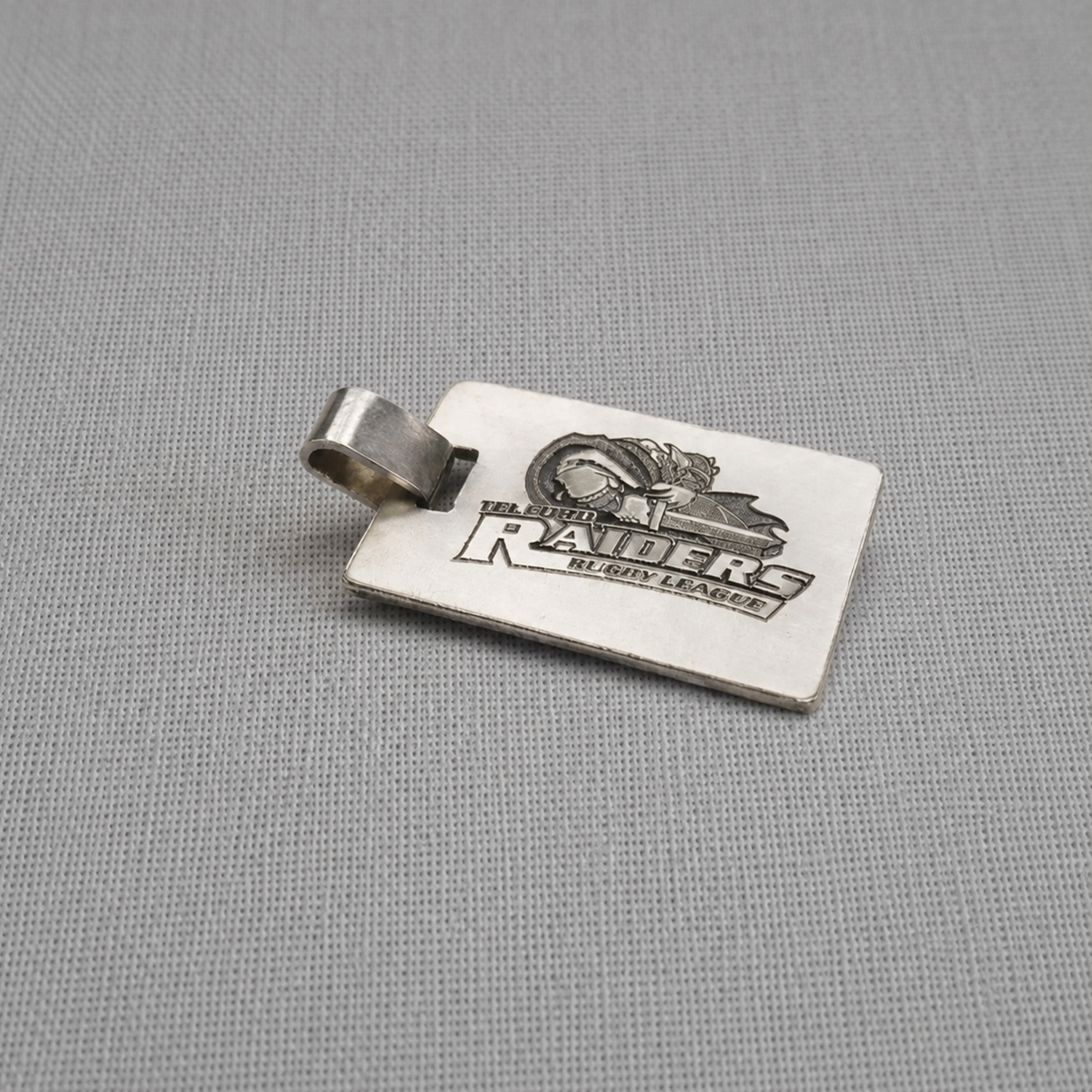 Personalised recycled silver dog tag pendant with custom engraving on fabric