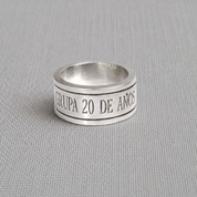 Engraved recycled silver spinning ring reading custom message on fabric