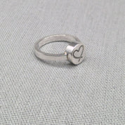 Side view of personalised silver ring showing raised disc detail