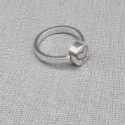 Alternate side view of engraved heart disc on recycled silver ring
