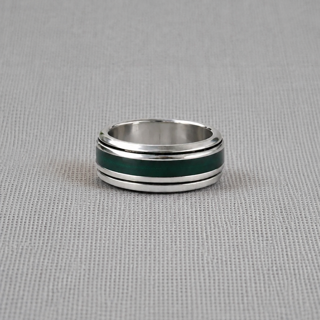 Personalised recycled silver spinning ring with green resin band on fabric