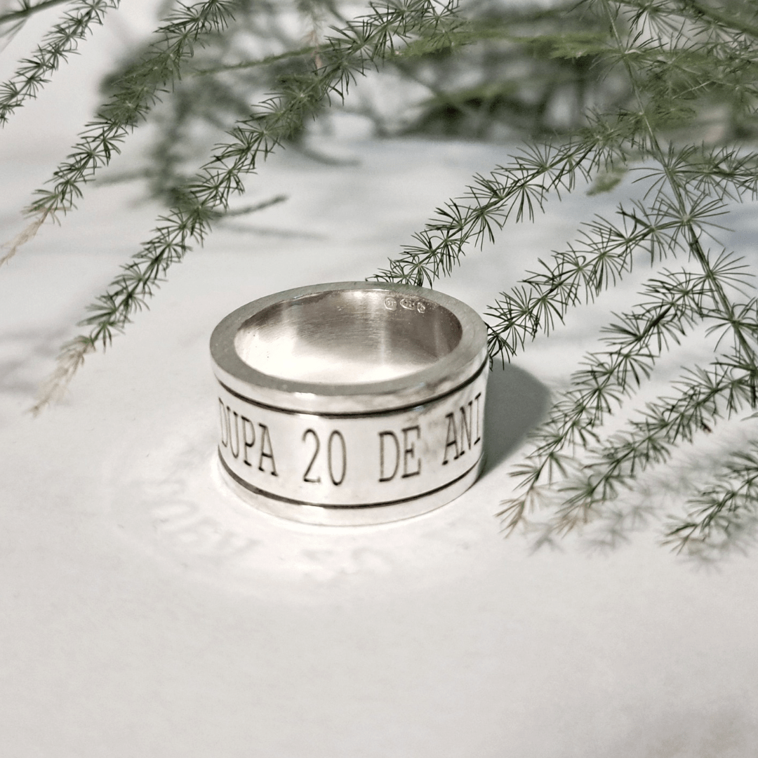 Side view of chunky recycled silver spinning ring with engraved band