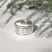 Side view of chunky recycled silver spinning ring with engraved band