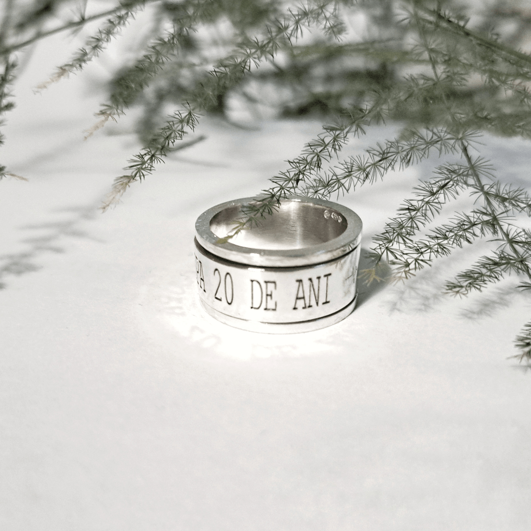 Top view of engraved recycled silver spinning ring showing custom text