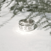 Top view of engraved recycled silver spinning ring showing custom text