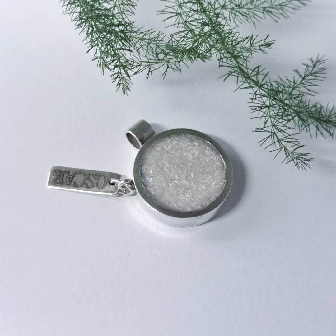 Close-up of memorial ashes pendant in outdoor natural light setting