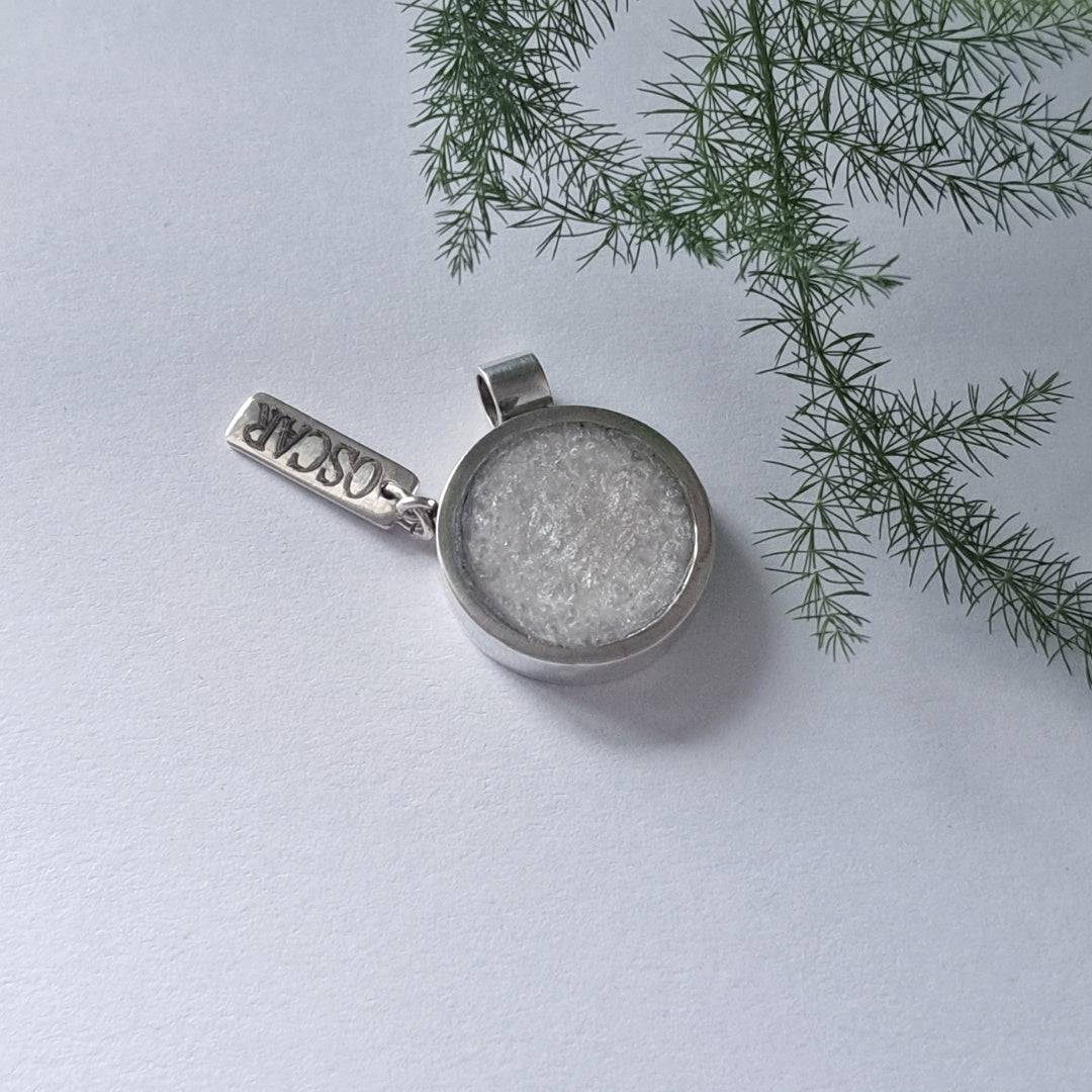 Side view of recycled silver memorial pendant showing resin ash centre