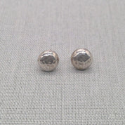 Detail shot of polished recycled silver ball stud earring