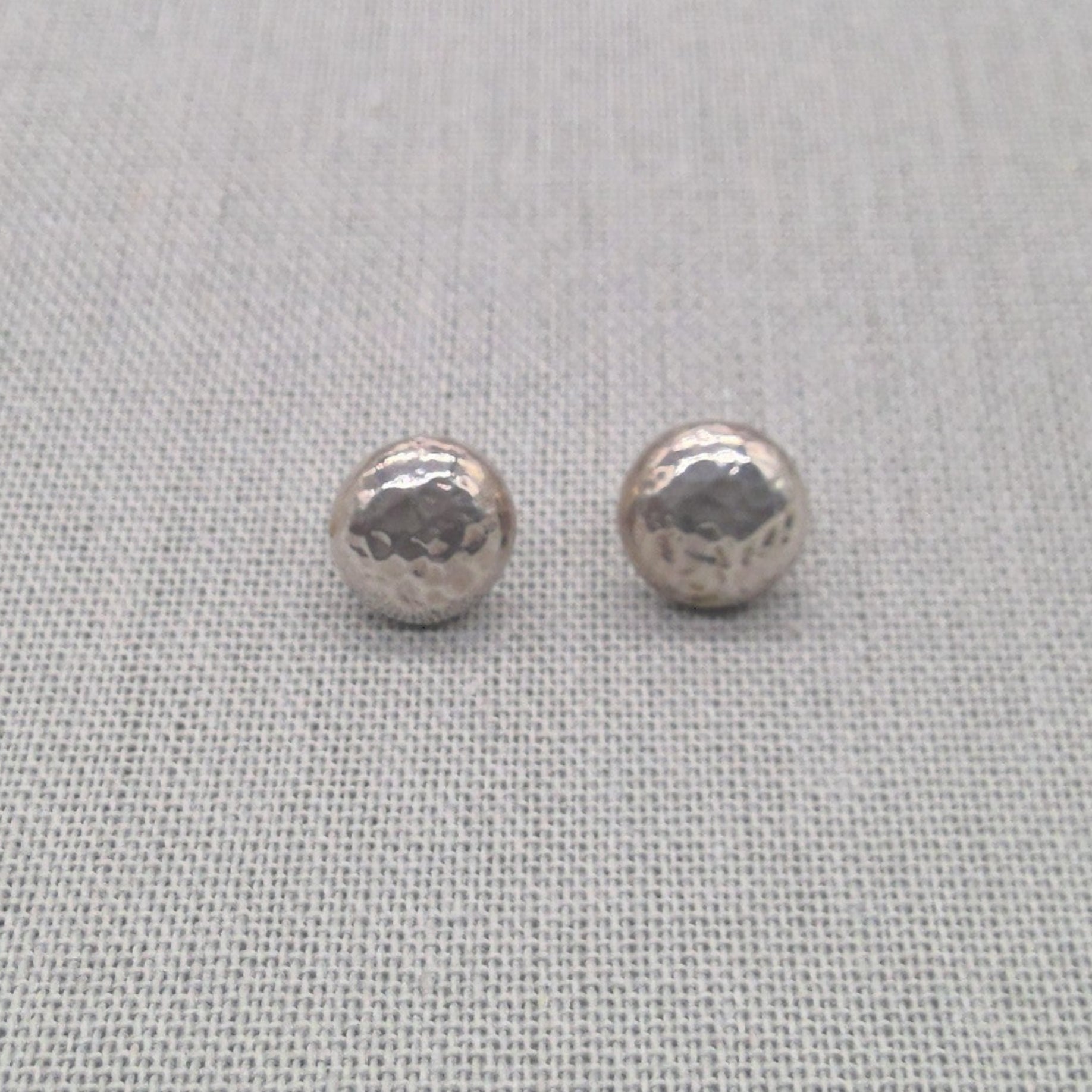 Detail shot of polished recycled silver ball stud earring