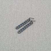 Detail shot of ear hook on black recycled silver chain earring