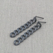 Close-up of oxidized black recycled silver chunky chain earrings