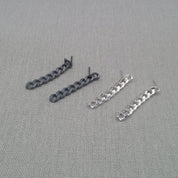 Black and silver-tone recycled silver chain earrings shown side by side
