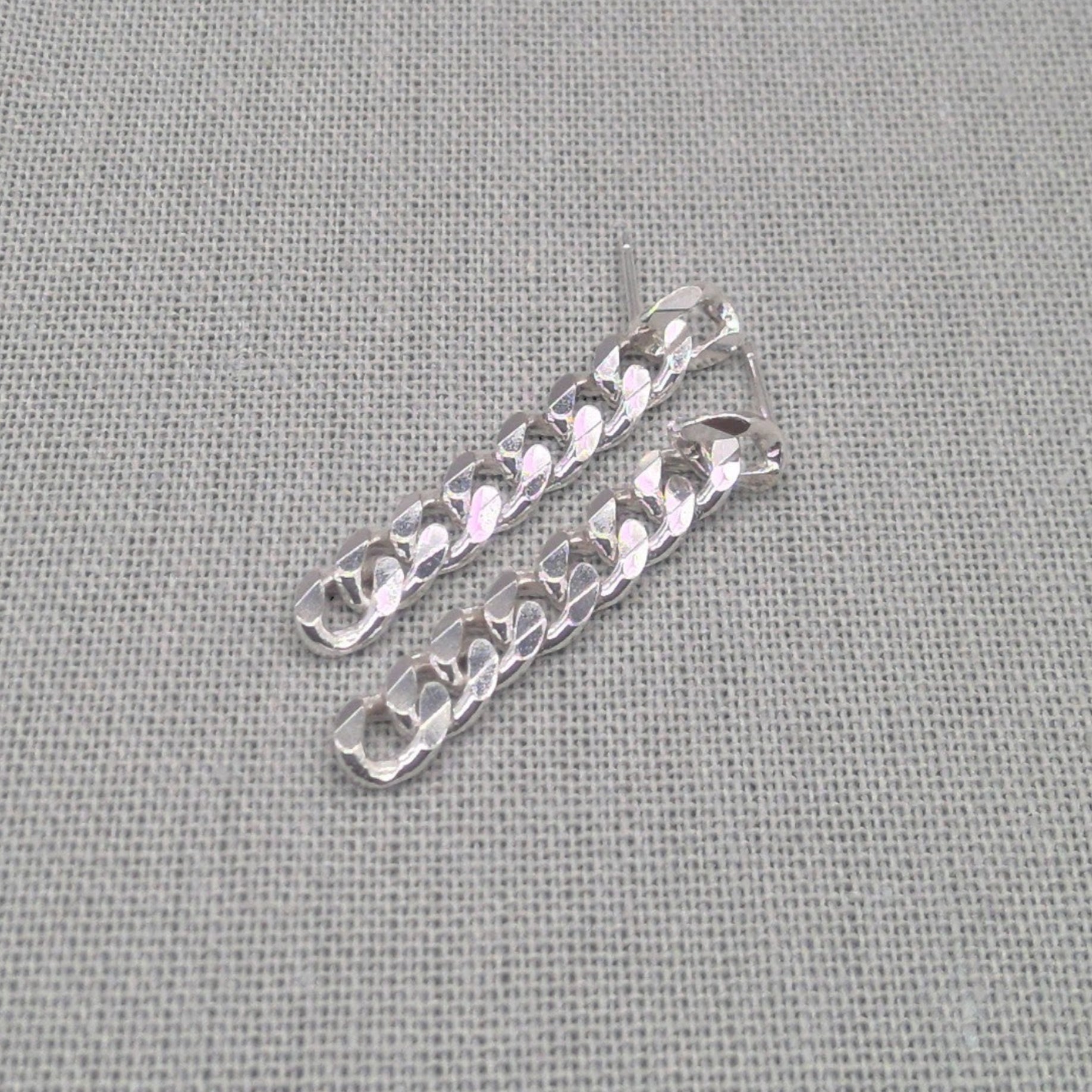 Angled view of silver-tone chunky chain earrings in recycled 925 silver