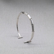 Close-up of segmented link detail on recycled silver bangle