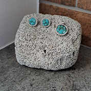 Decorative stone with turquoise accents on a concrete surface