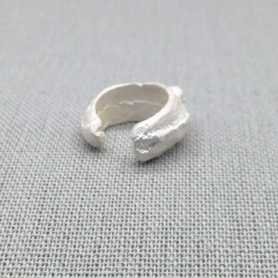 Alternate side view of textured recycled silver ear cuff