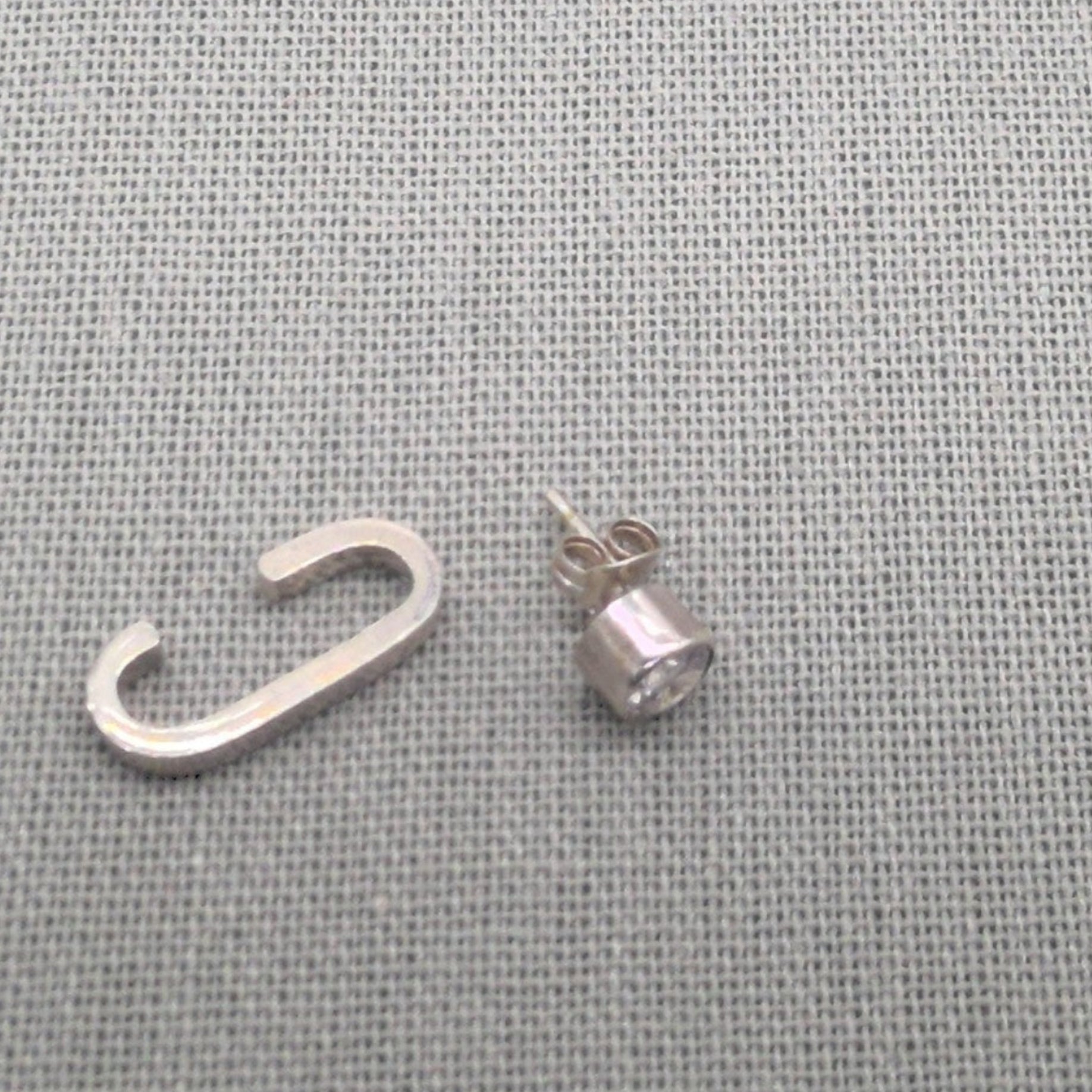 Side view of recycled silver cuff and zircon stud earring set