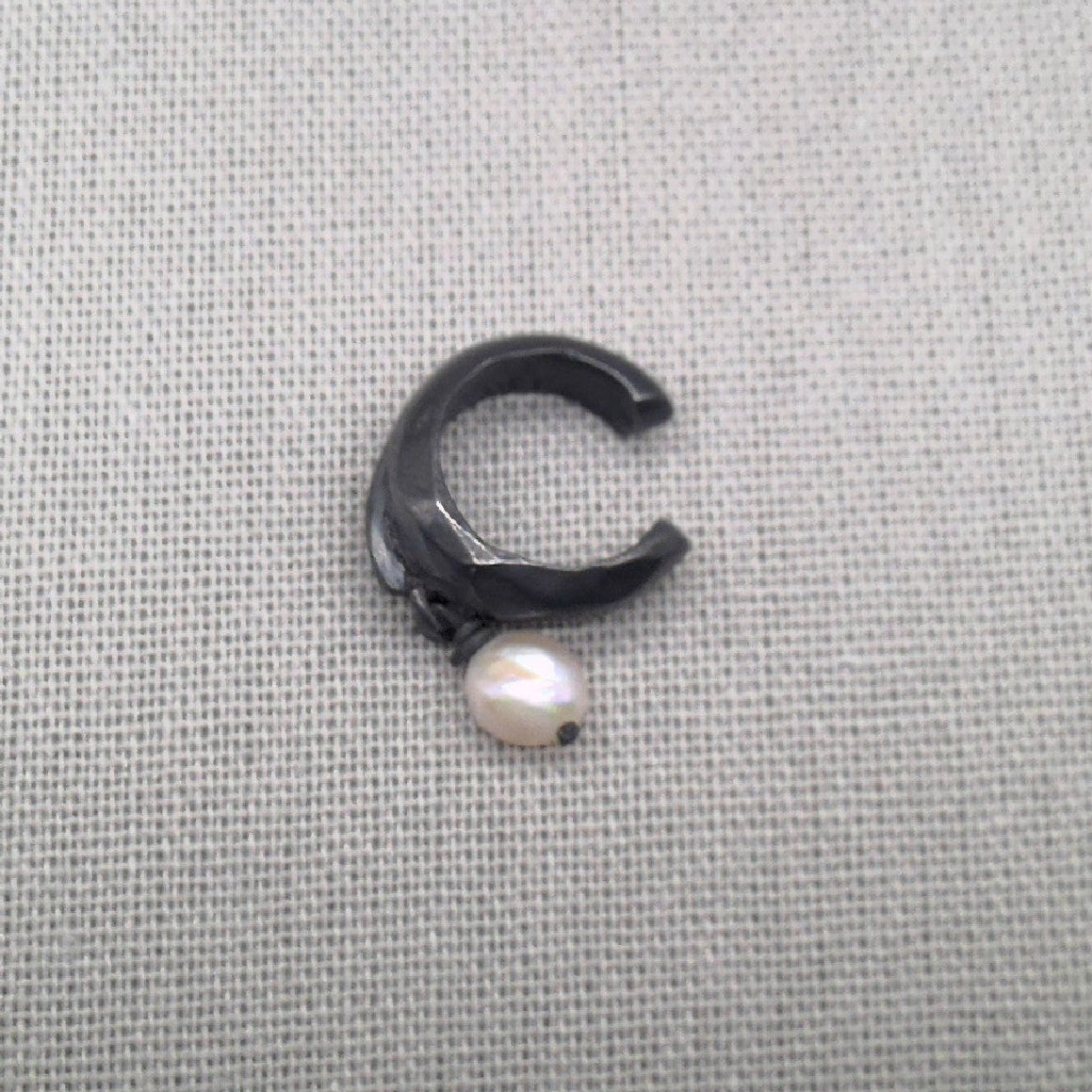 Front view of open oxidized silver ear cuff with pearl