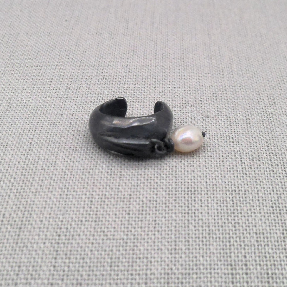 Side view of oxidized silver ear cuff with pearl detail