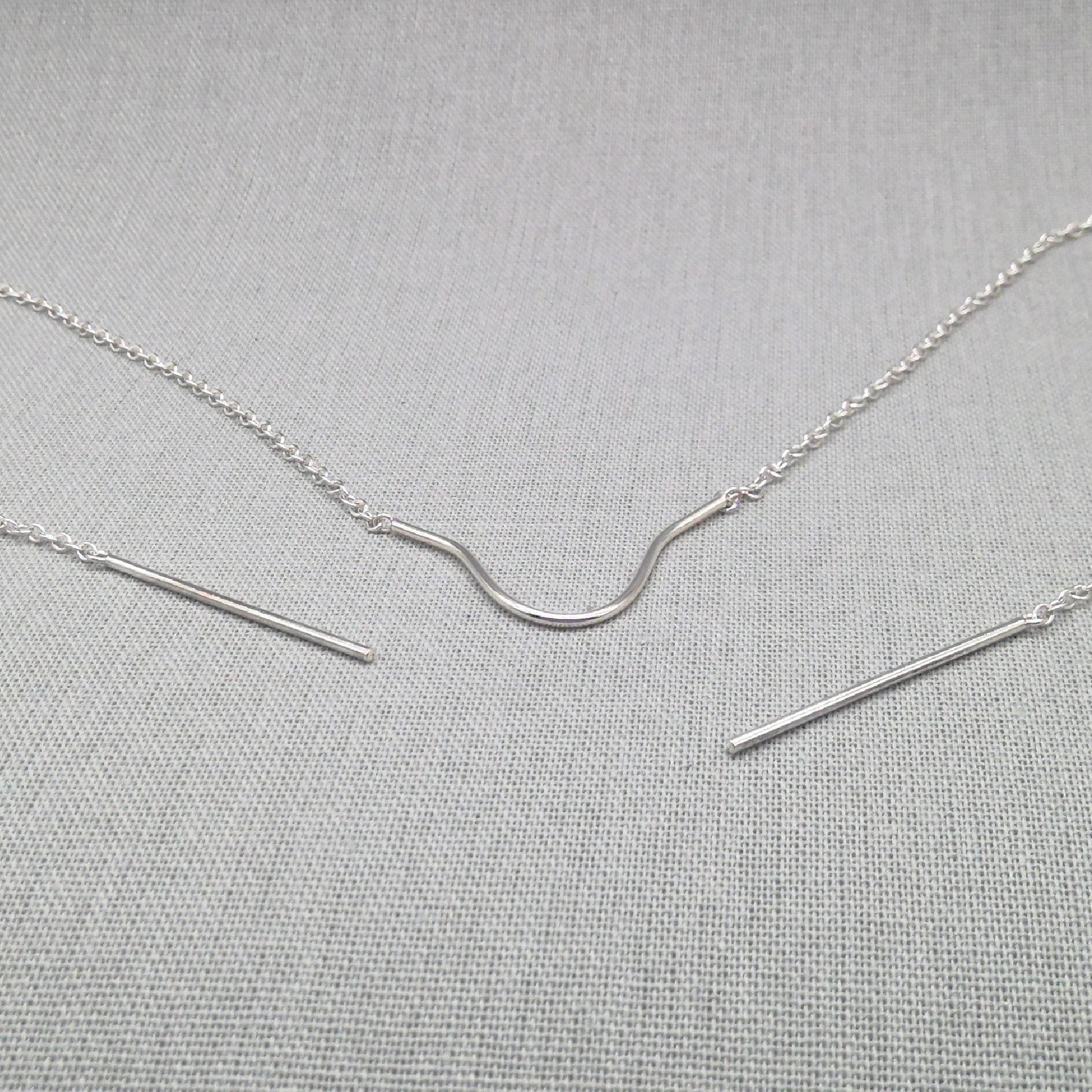 Recycled silver face chain laid flat showing draped chain shape