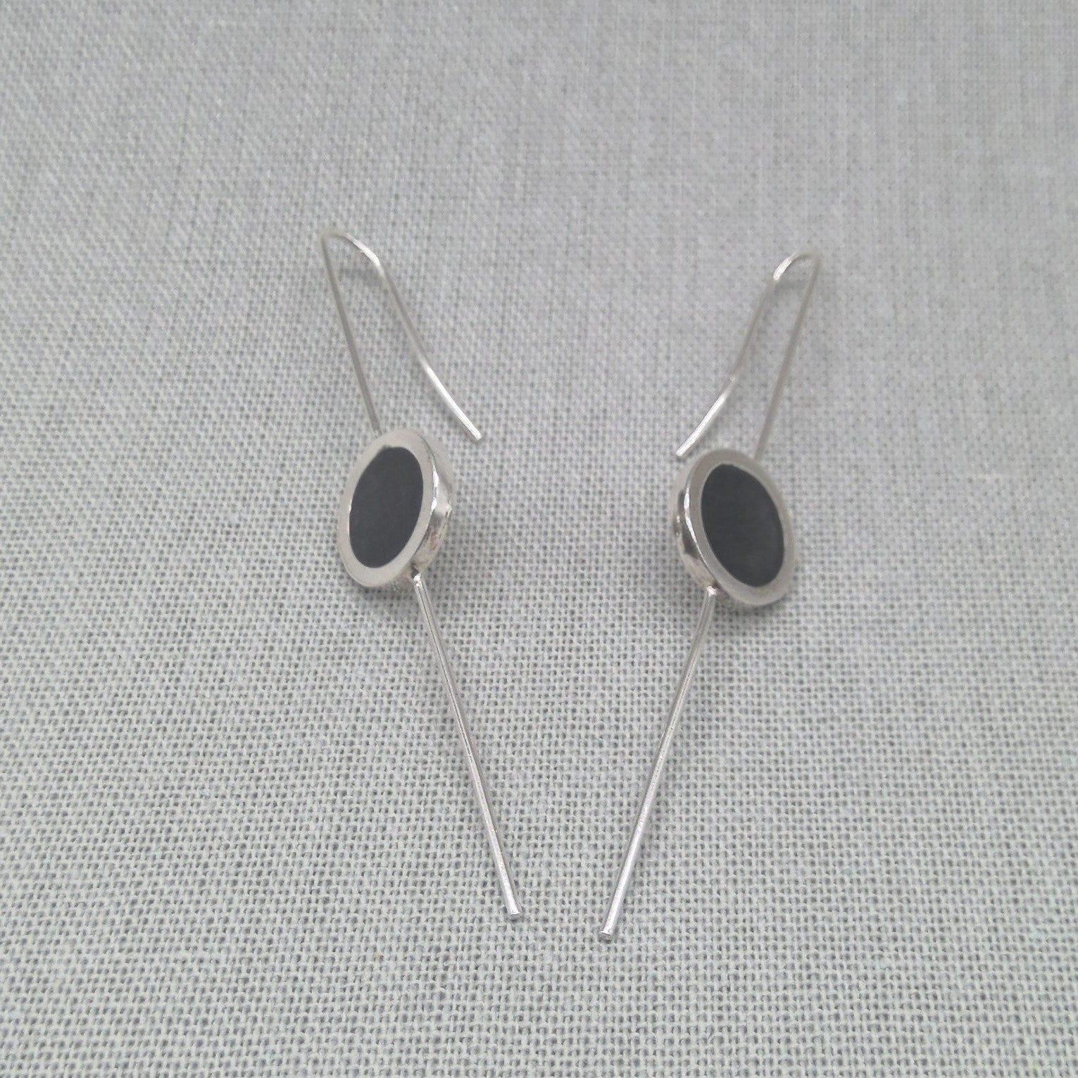 Silver and resin earrings styled in angled V position
