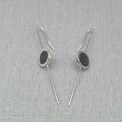 Silver and resin earrings styled in angled V position